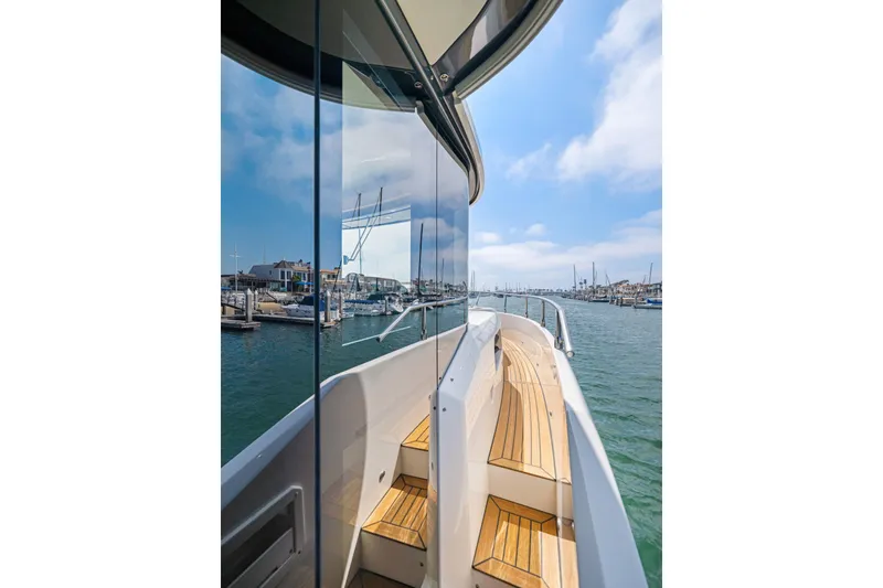 Slide: The Image of 2018 Absolute Navetta 52 yacht with wooden deck, docked in a marina. - 27