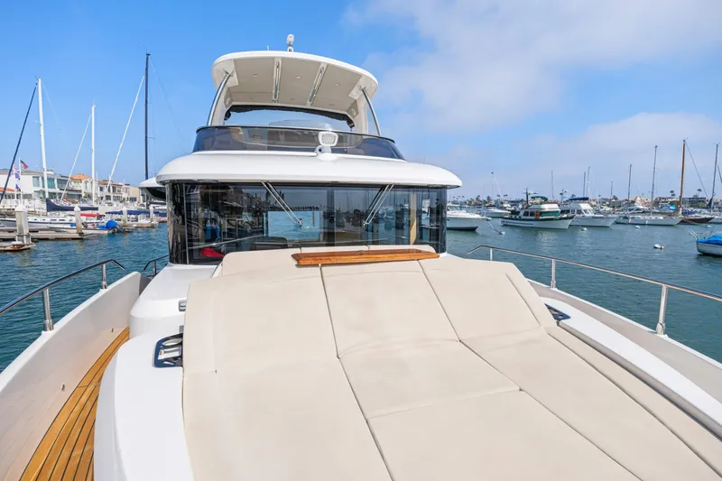 Slide: The Image of 2018 Absolute Navetta 52 yacht docked in a marina, featuring spacious deck and modern design. - 28
