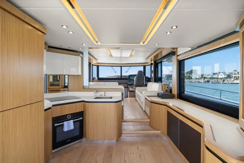 Slide: The Image of Luxurious interior of 2018 Absolute Navetta 52 yacht with modern kitchen and panoramic windows. - 3