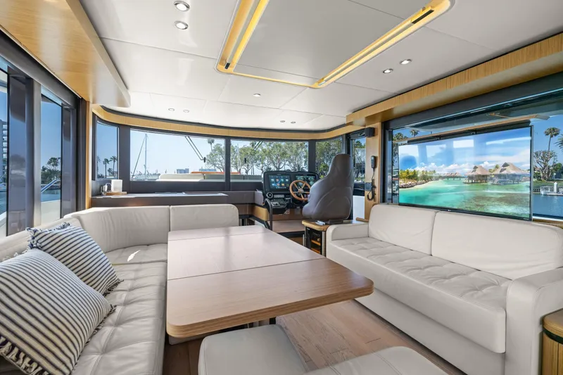Slide: The Image of Luxurious interior of 2018 Absolute Navetta 52 yacht with panoramic windows and elegant seating. - 7