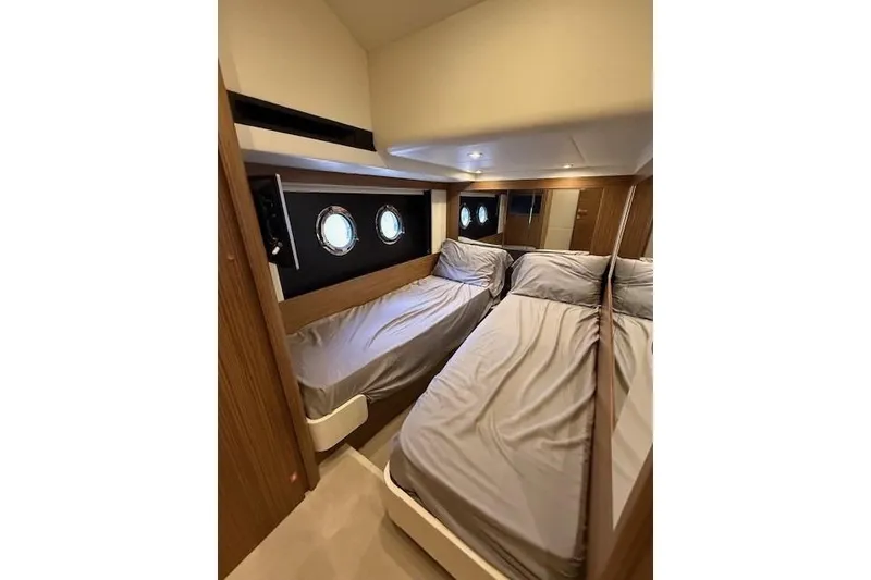 Slide: The Image of Luxurious twin cabin interior of 2018 Absolute Navetta 52 yacht with porthole windows. - 11
