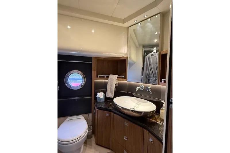 Slide: The Image of Luxurious bathroom in 2018 Absolute Navetta 52 yacht with modern fixtures and porthole window. - 18