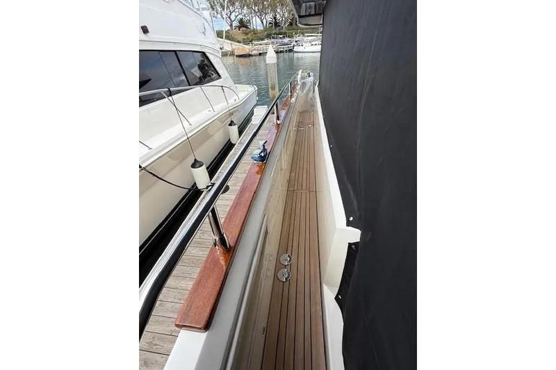 Slide: The Image of Side view of 2018 Absolute Navetta 52 yacht docked at marina. - 19
