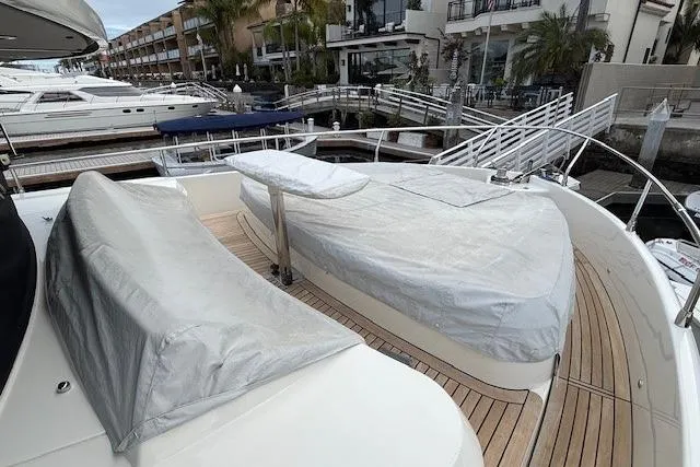 Slide: The Image of 2018 Absolute Navetta 52 yacht with covered seating area at marina. - 20