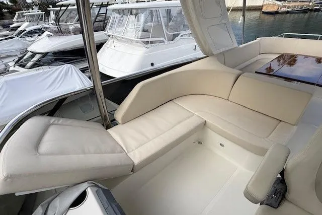 Slide: The Image of Luxurious seating area on a 2018 Absolute Navetta 52 yacht, docked at a marina. - 21