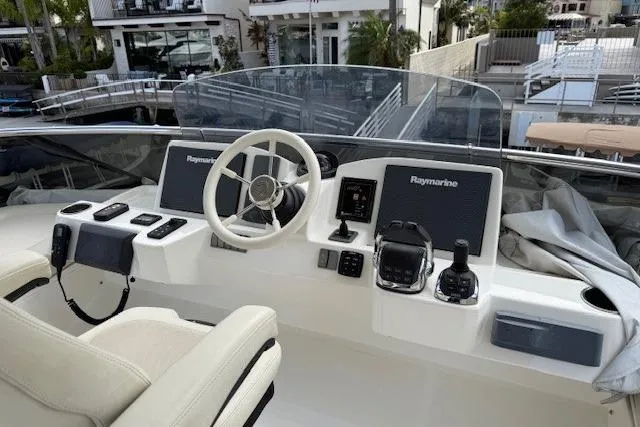 Slide: The Image of 2018 Absolute Navetta 52 yacht helm with Raymarine navigation systems and white steering wheel. - 24
