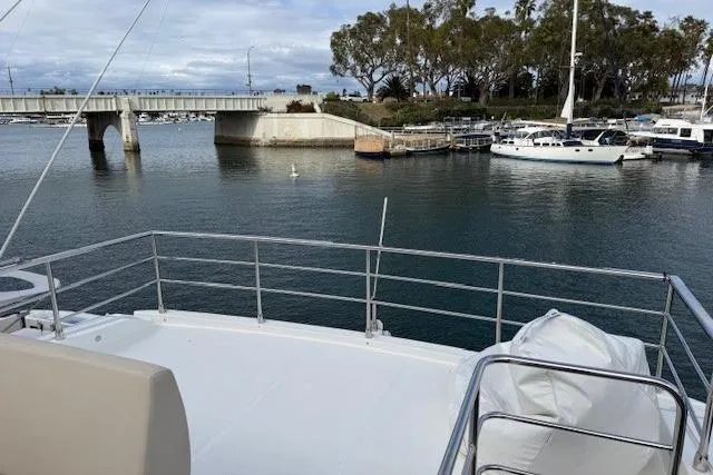 Slide: The Image of 2018 Absolute Navetta 52 yacht docked near a bridge in a serene marina. - 25