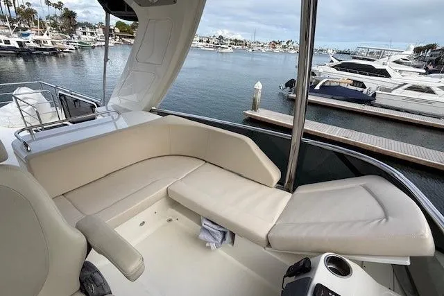Slide: The Image of Luxurious seating area on a 2018 Absolute Navetta 52 yacht, docked at a marina. - 26