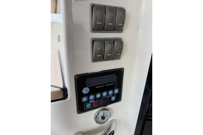 Slide: The Image of Control panel of 2018 Absolute Navetta 52 yacht with switches and display. - 28