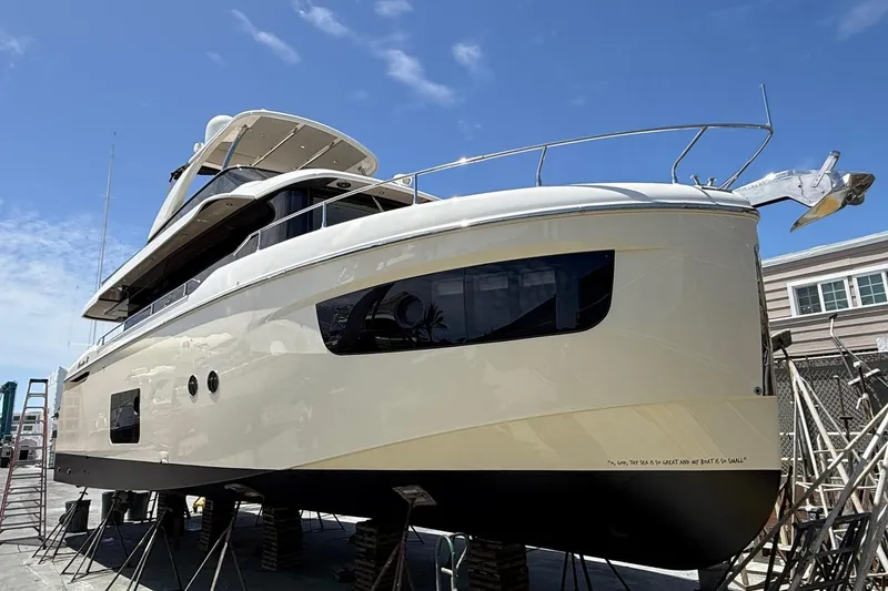 Slide: The Image of 2018 Absolute Navetta 52 yacht on dry dock under clear blue sky. - 34