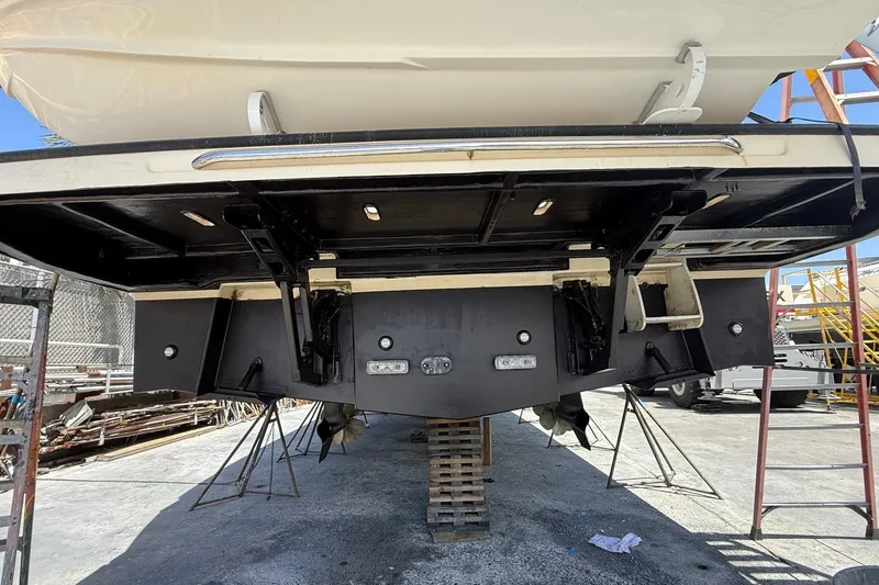Slide: The Image of 2018 Absolute Navetta 52 yacht under maintenance, showing hull and propeller details. - 35