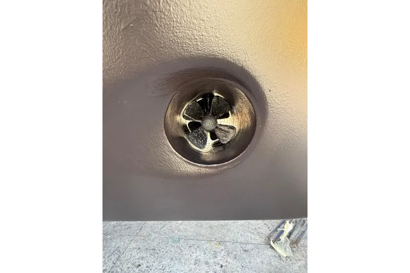 Slide: The Image of Close-up of a 2018 Absolute Navetta 52 boat thruster, showcasing its propeller design. - 36