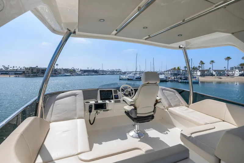 Slide: The Image of Flybridge of 2018 Absolute Navetta 52 yacht overlooking marina with clear skies. - 37