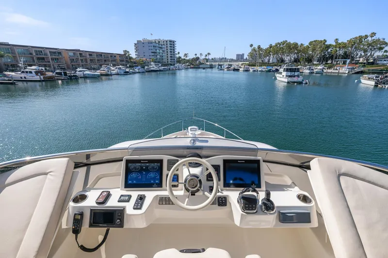Slide: The Image of Cockpit view of 2018 Absolute Navetta 52 yacht in a marina setting. - 38