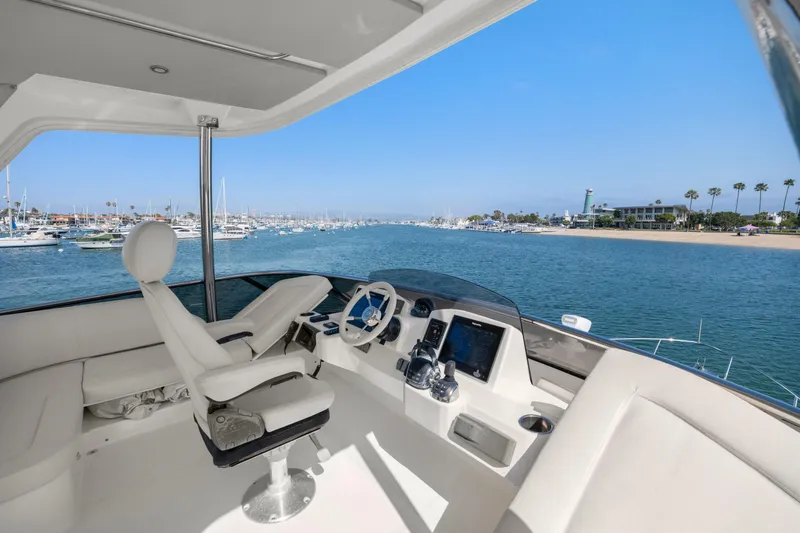 Slide: The Image of Luxurious helm of 2018 Absolute Navetta 52 yacht overlooking marina and coastline. - 39