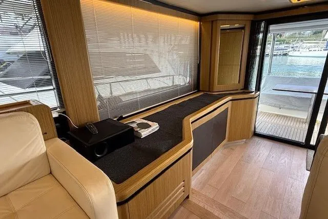 Slide: The Image of Luxurious interior of 2018 Absolute Navetta 52 yacht with elegant wood finishes and waterfront view. - 5