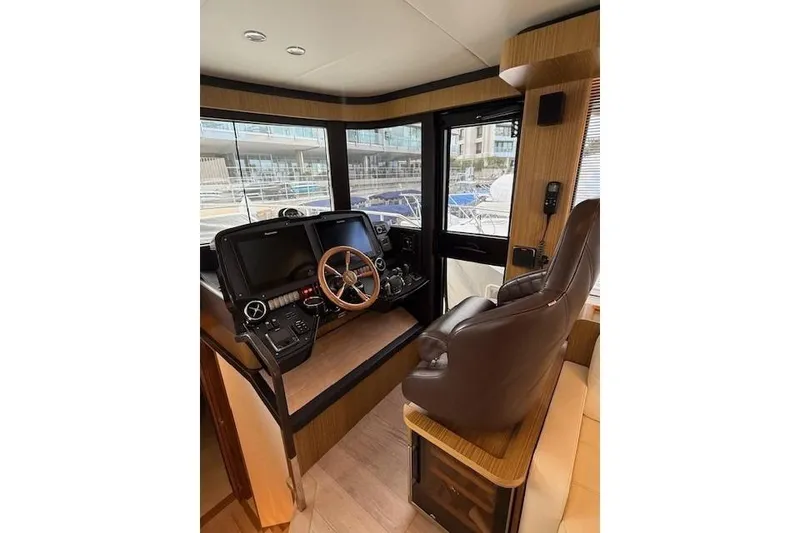 Slide: The Image of Cockpit of 2018 Absolute Navetta 52 yacht with modern controls and leather seating. - 6