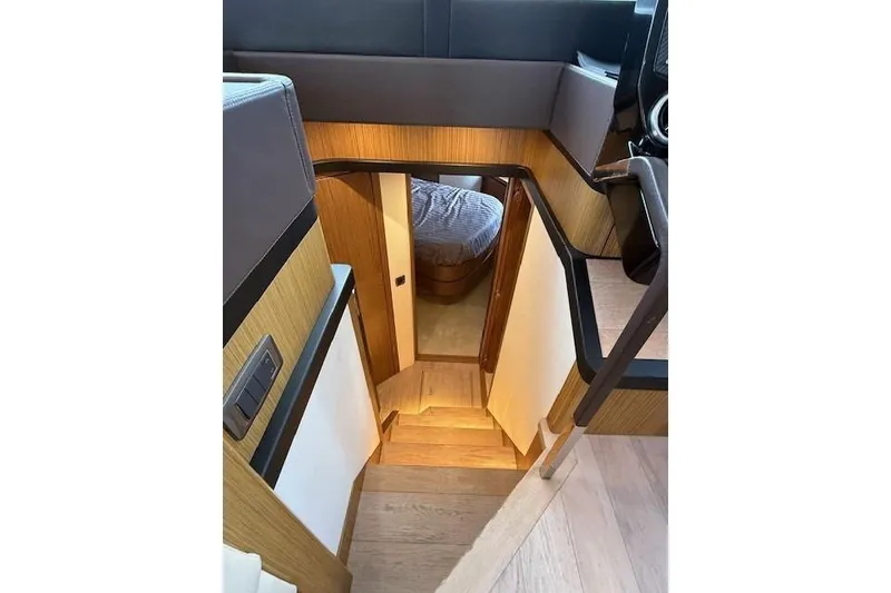 Slide: The Image of Interior view of 2018 Absolute Navetta 52 yacht, featuring wooden stairs and cozy cabin entrance. - 7