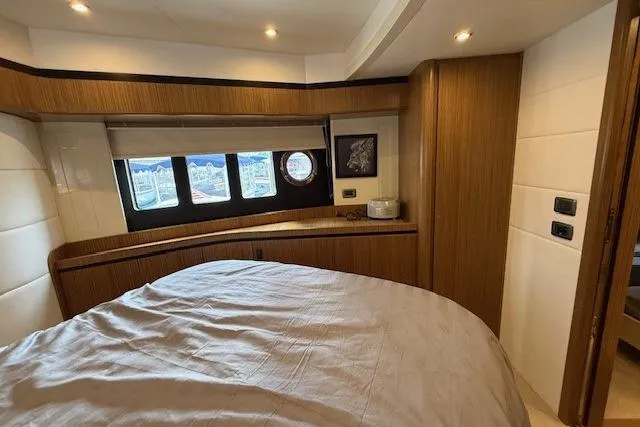 Slide: The Image of Luxurious cabin interior of 2018 Absolute Navetta 52 yacht with wood accents and porthole windows. - 9