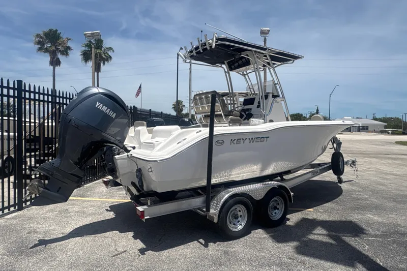 The Image of 2024 Key West 219 FS boat on trailer with Yamaha outboard motor, parked outdoors. - 1