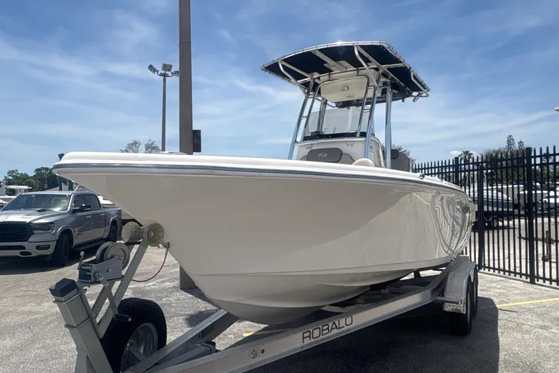 Slide: The Image of 2024 Key West 219 FS boat on trailer under clear blue sky. - 3