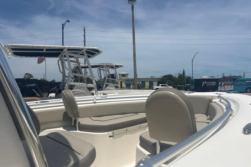Slide: The Image of 2024 Key West 219 FS boat interior with seating, under a clear blue sky. - 5