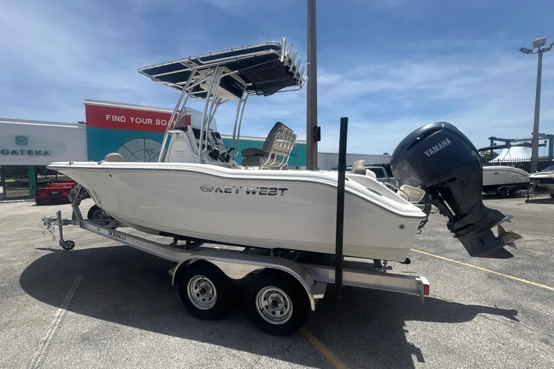 Slide: The Image of 2024 Key West 219 FS boat on trailer with Yamaha outboard motor, parked outdoors. - 9
