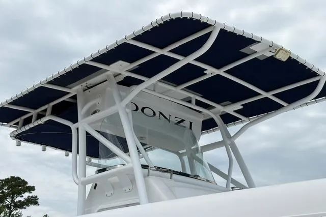 Slide: The Image of 2007 Donzi 38 ZF Open boat with blue canopy against cloudy sky. - 15