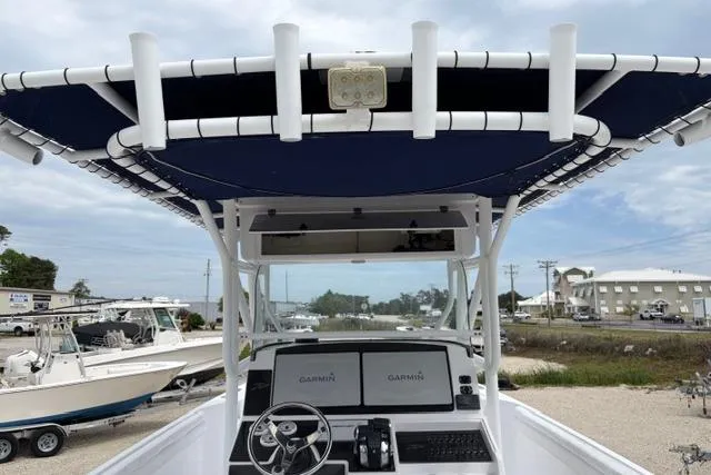 Slide: The Image of 2007 Donzi 38 ZF Open boat with Garmin navigation, docked in a marina setting. - 17