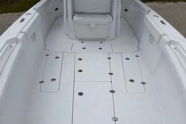 Slide: The Image of 2007 Donzi 38 ZF Open boat interior with white deck and storage compartments. - 19