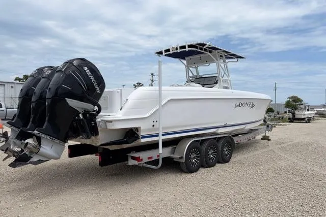 Slide: The Image of 2007 Donzi 38 ZF Open boat on trailer with triple Mercury outboard engines. - 2