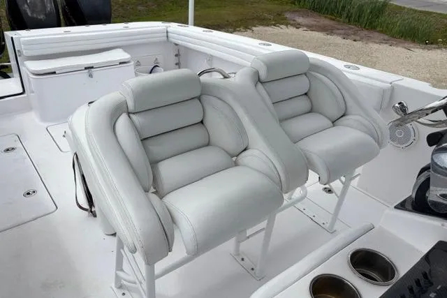 Slide: The Image of 2007 Donzi 38 ZF Open boat interior with white cushioned seating and cup holders. - 24