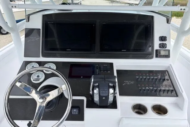 Slide: The Image of 2007 Donzi 38 ZF Open boat dashboard with dual screens and steering wheel. - 29