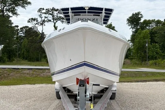 Slide: The Image of 2007 Donzi 38 ZF Open boat on trailer, front view, surrounded by trees. - 3