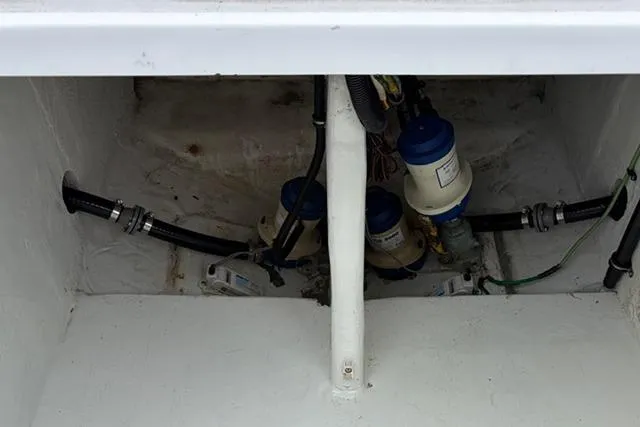Slide: The Image of 2007 Donzi 38 ZF Open boat engine compartment with visible hoses and filters. - 36
