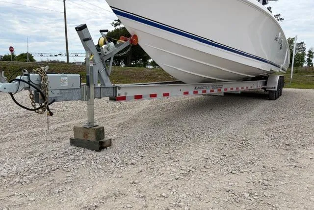 Slide: The Image of 2007 Donzi 38 ZF Open boat on a trailer, parked on gravel. - 4