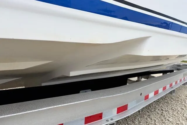 Slide: The Image of 2007 Donzi 38 ZF Open boat hull on trailer, showcasing sleek design and blue accents. - 6