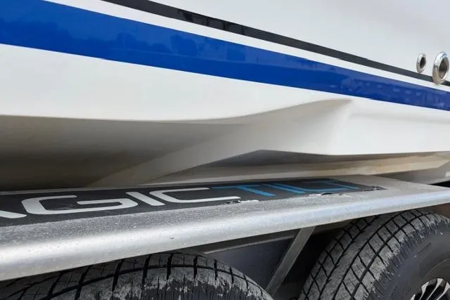 Slide: The Image of 2007 Donzi 38 ZF Open boat on trailer, showcasing sleek hull design and blue stripe. - 8
