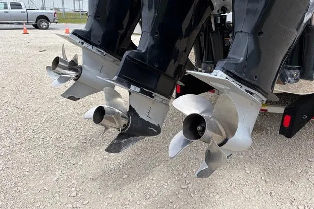 Slide: The Image of Twin outboard motors on a 2007 Donzi 38 ZF Open boat, parked on gravel. - 9