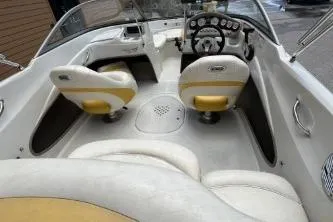 Slide: The Image of 2013 Tahoe Q4 SF boat interior with white and yellow seating, steering wheel, and dashboard controls. - 3