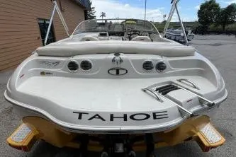 Slide: The Image of 2013 Tahoe Q4 SF boat, rear view, parked outdoors. - 4