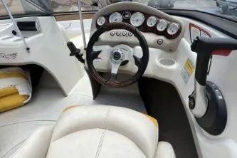 Slide: The Image of Interior of a 2013 Tahoe Q4 SF boat, featuring steering wheel and dashboard controls. - 5