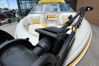 Slide: The Image of 2013 Tahoe Q4 SF boat with white and yellow seating, docked outdoors. - 6
