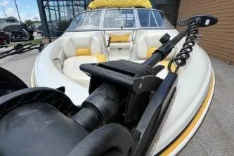 Slide: The Image of 2013 Tahoe Q4 SF boat with white and yellow seating, docked outdoors. - 7