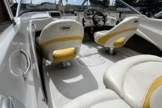 Slide: The Image of 2013 Tahoe Q4 SF boat interior with white and yellow seating, steering wheel, and dashboard. - 8