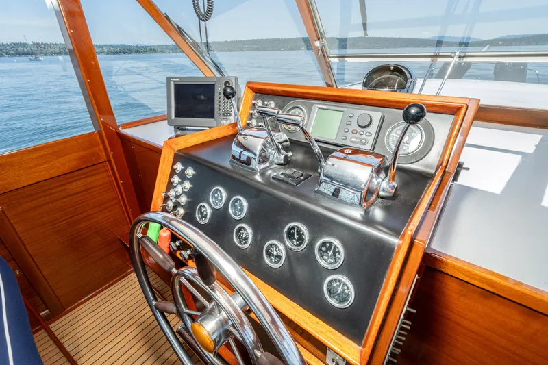 Slide: The Image of Helm of 1965 Chris-Craft 57 Constellation yacht with classic wooden dashboard and controls. - 14