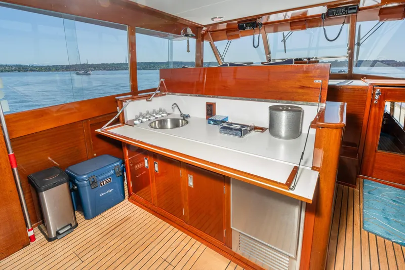 Slide: The Image of 1965 Chris-Craft 57 Constellation yacht interior with wooden cabinetry and sink. - 18