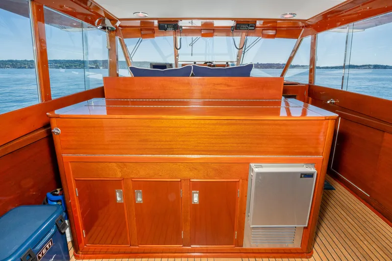 Slide: The Image of 1965 Chris-Craft 57 Constellation interior with polished wood cabinetry and scenic water view. - 20