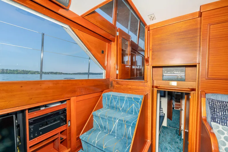 Slide: The Image of Interior of 1965 Chris-Craft 57 Constellation yacht with wooden paneling and blue carpeted stairs. - 28