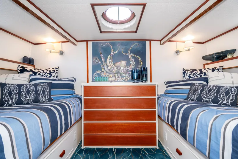 Slide: The Image of Interior of 1965 Chris-Craft 57 Constellation with nautical-themed decor and twin beds. - 35
